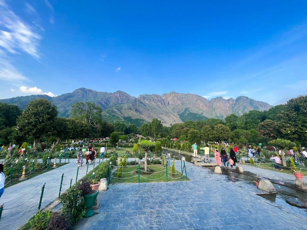 Zabarwan Mountain Range viewed from Nishat Bagh in Srinagar, Kashmir, with manicured Mughal garden lawns in the foreground.