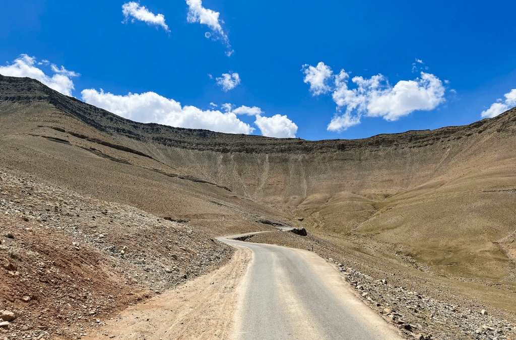 Winding road through barren rocky hills under a blue sky near Batalik Kargil Ladakh