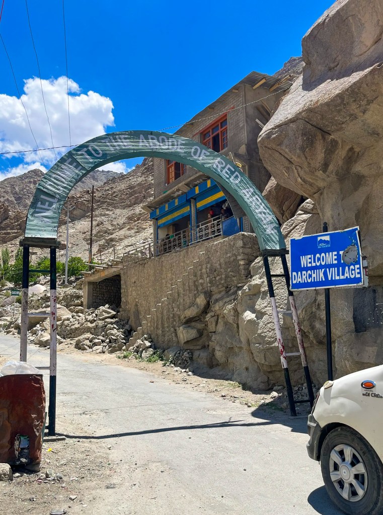 Entrance arch and signboard welcoming visitors to Darchik village in Aryan Valley Ladakh