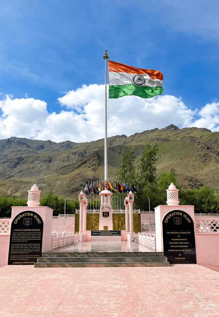 Indian flag flying over Kargil War Memorial with mountains in the background at Drass Ladakh